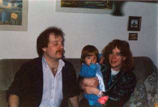 Eltern mit kleinem Kind auf Couch